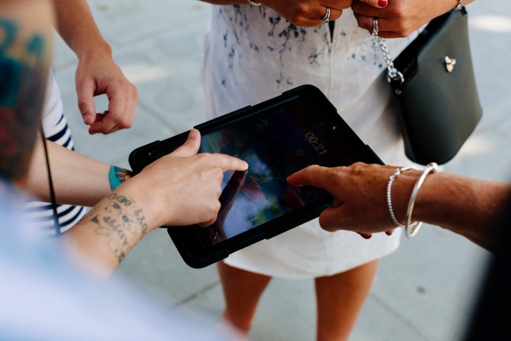 People enjoying an iPad Treaure Hunt in one of London's parks