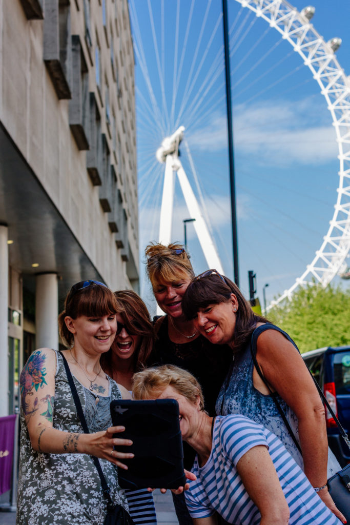 A team participating in a treasure hunt outside the London Eye