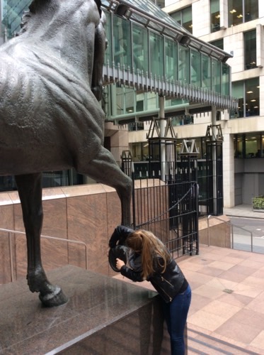 An image of someone taking a picture with a horse statue