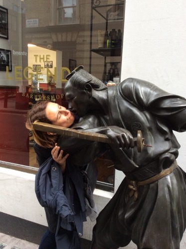 A picture of someone kissing a statue as part of Cluego treasure hunt